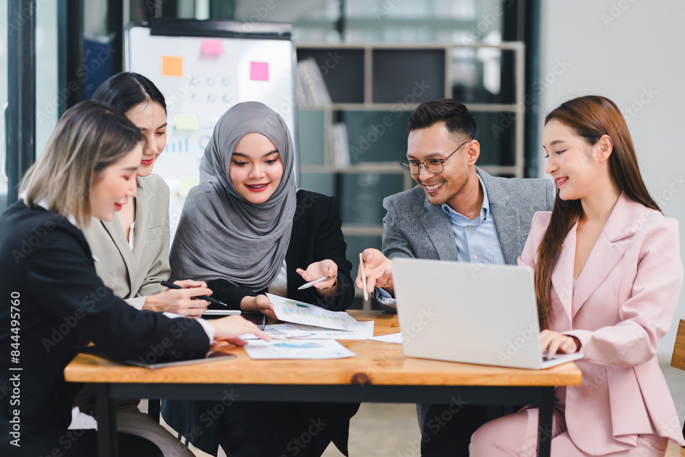 Diverse business team analyzing data and discussing strategies during an office meeting, using documents and a laptop. Diverse business team analyzing data and discussing strategies during an office meeting, using documents and a laptop.