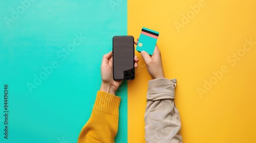 Obraz na płótnie Close-up of hands holding a smartphone and a credit card, modern digital payment, minimalistic background, bright colors, high resolution w salonie