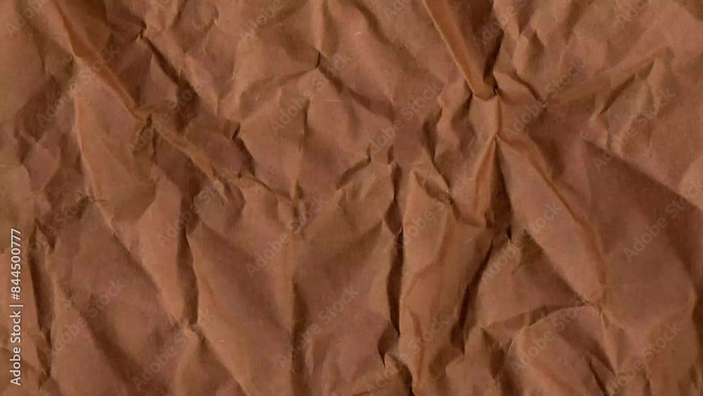 Stop motion of brown texture paper background. Crumpled Dirty Brown Paper. Looped Paper Animated Texture. Old paper texture background. Old Vintage color. Abstract grunge texture wall backdrop. Stop motion of brown texture paper background. Crumpled Dirty Brown Paper. Looped Paper Animated Texture. Old paper texture background. Old Vintage color. Abstract grunge texture wall backdrop.