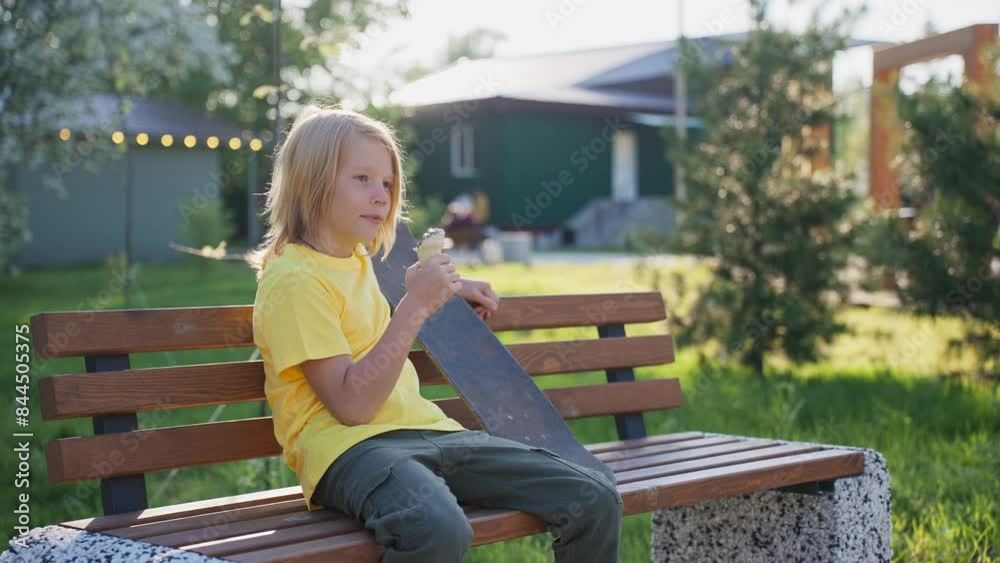 Teenager Eats Ice Cream on a Park Bench in Summer Teenager Eats Ice Cream on a Park Bench in Summer