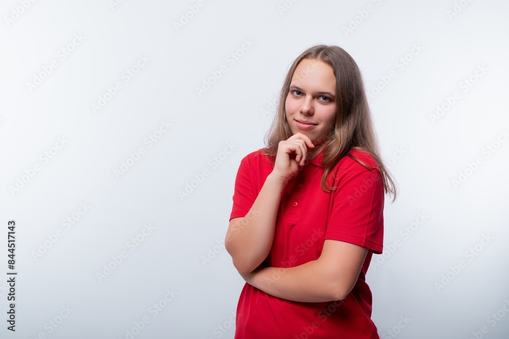 A puzzled girl with brown hair looks to the side in surprise and attentively A puzzled girl with brown hair looks to the side in surprise and attentively
