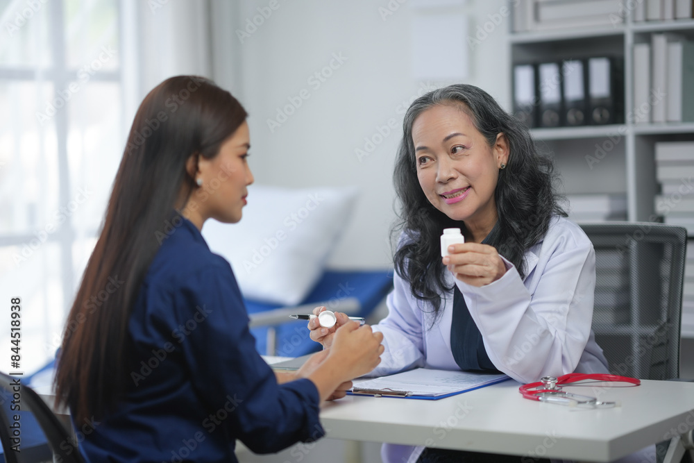 Female doctor consulting young woman patient in clinic office, discussing medication. Professional healthcare and medical advice scene. Female doctor consulting young woman patient in clinic office, discussing medication. Professional healthcare and medical advice scene.