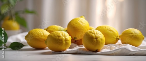 Fresh lemons on white fabric background with shades Beautiful backdrop. photo