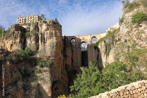Rocky landscape of Ronda city with Puente Nuevo Bridge and buildings, Andalusia, Spain 