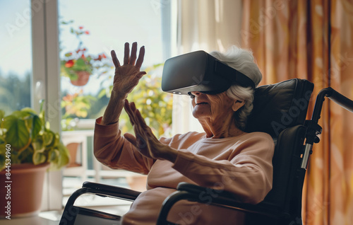 A senior woman is using a VR headset while seated in a wheelchair next to a window photo