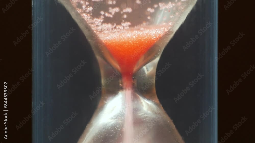 Red sand in hourglass, time flows backwards, in opposite direction. Time cures all things. Time is great healer. Time works wonders