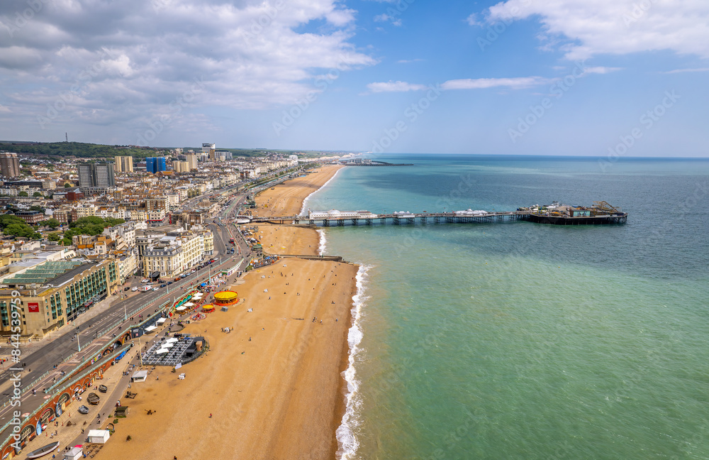 The drone aerial view of Brighton Pier and the beach of Brighton. The Brighton Palace Pier, is a pleasure pier in Brighton, England, located in the city centre opposite the Old Steine. The drone aerial view of Brighton Pier and the beach of Brighton. The Brighton Palace Pier, is a pleasure pier in Brighton, England, located in the city centre opposite the Old Steine.