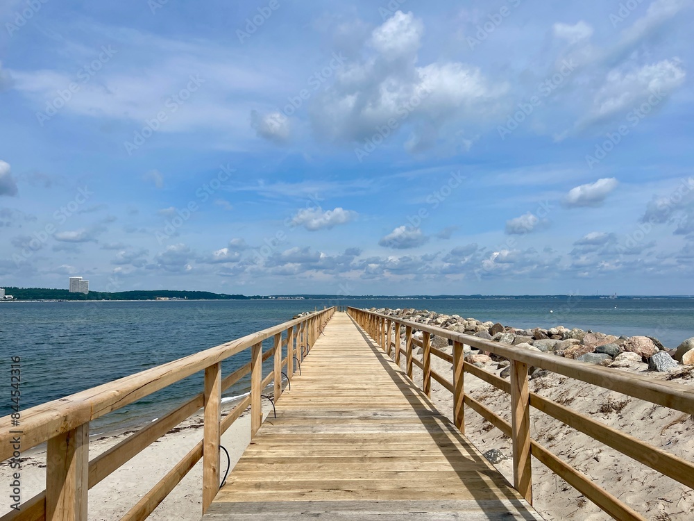 wooden bridge over the sea on a summer day wooden bridge over the sea on a summer day