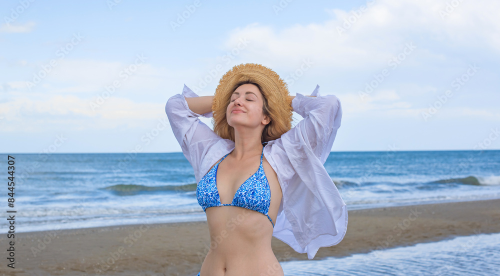 Concept of beach recreation, vacation time at warm climate. Girl on a sunny day at sea Concept of beach recreation, vacation time at warm climate. Girl on a sunny day at sea