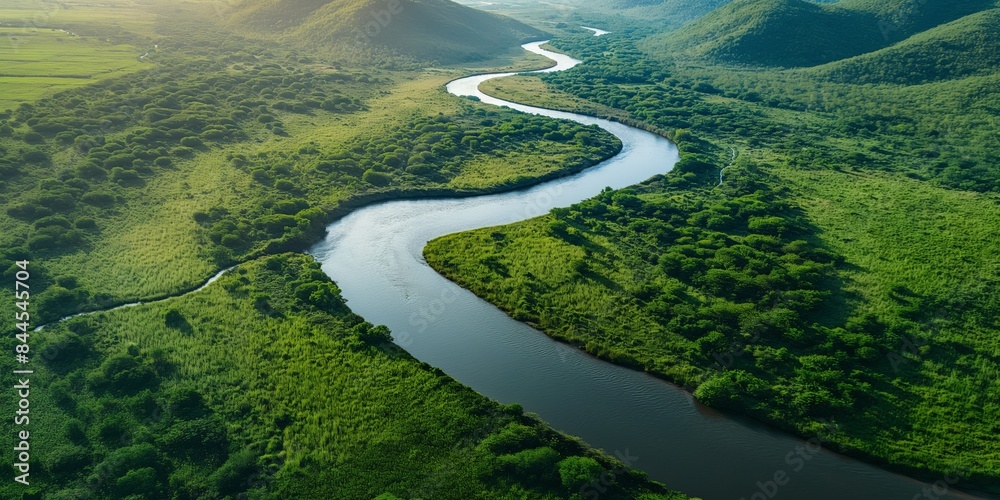 A river meandering through a verdant green valley, surrounded by undulating hills and lush foliage. An idyllic and natural scene illustrating tranquility and harmony. A river meandering through a verdant green valley, surrounded by undulating hills and lush foliage. An idyllic and natural scene illustrating tranquility and harmony.