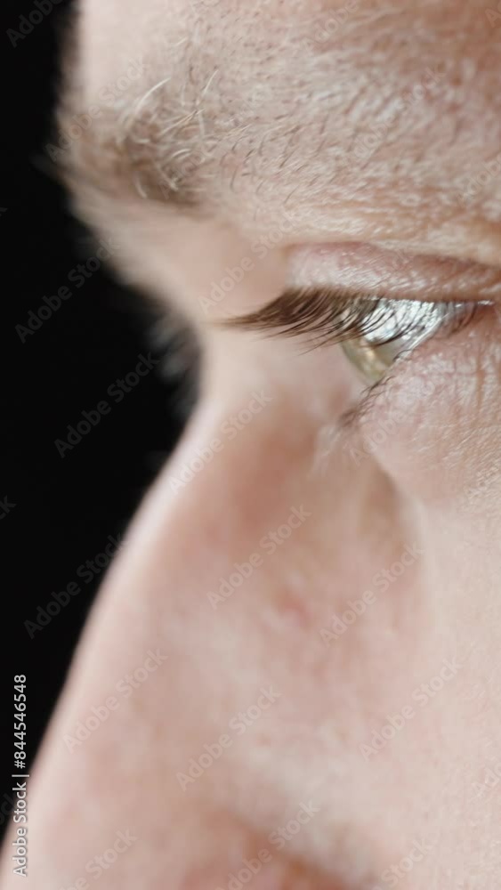 A Man Face Looking at Something Bright and Flashing, Macro. Concept of Looking at a Screen. A Man Face Looking at Something Bright and Flashing, Macro. Concept of Looking at a Screen.
