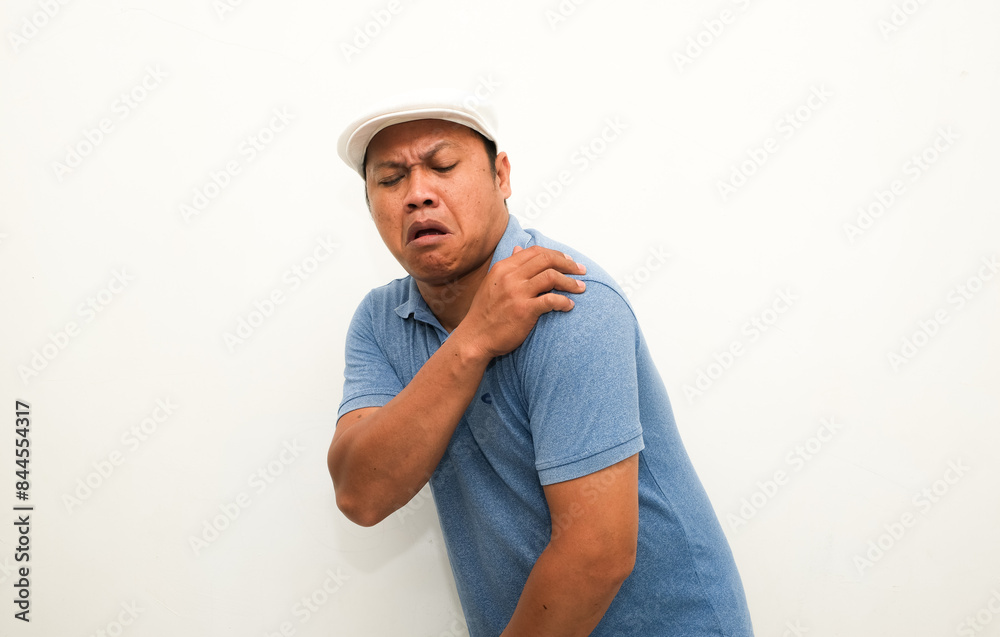portrait of a asian man with pain in his shoulder portrait of a asian man with pain in his shoulder