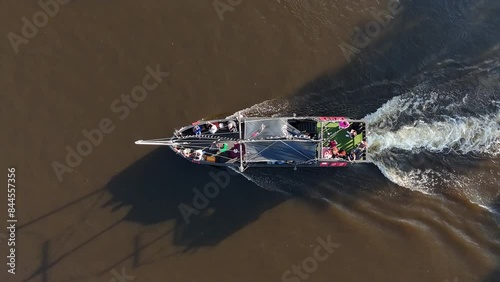 Aerial top-down view of a party boat cruising along the Neris River in Vilnius, Lithuania. photo