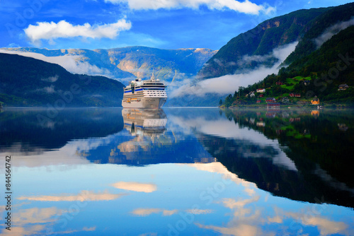 Ulwik. Cruise ship anchored in Ulwik fjord in Norway. Amazing nature view with fjord and mountains. Beautiful reflection.	
