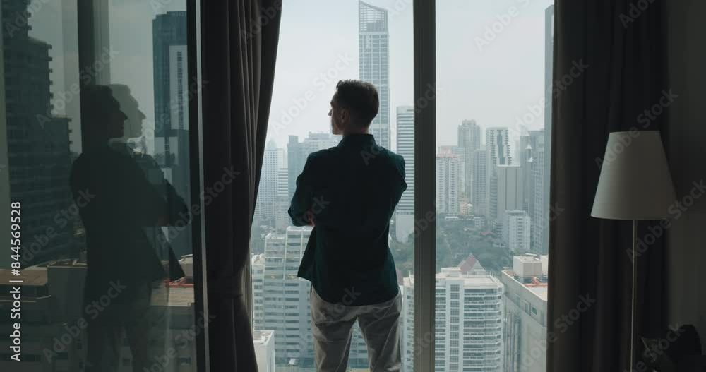 Opening up majestic panoramic view of modern metropolis person looks beautiful architecture from urban apartment back view. Panoramic windows symbolize harmony between hustle and bustle of city life. Opening up majestic panoramic view of modern metropolis person looks beautiful architecture from urban apartment back view. Panoramic windows symbolize harmony between hustle and bustle of city life.