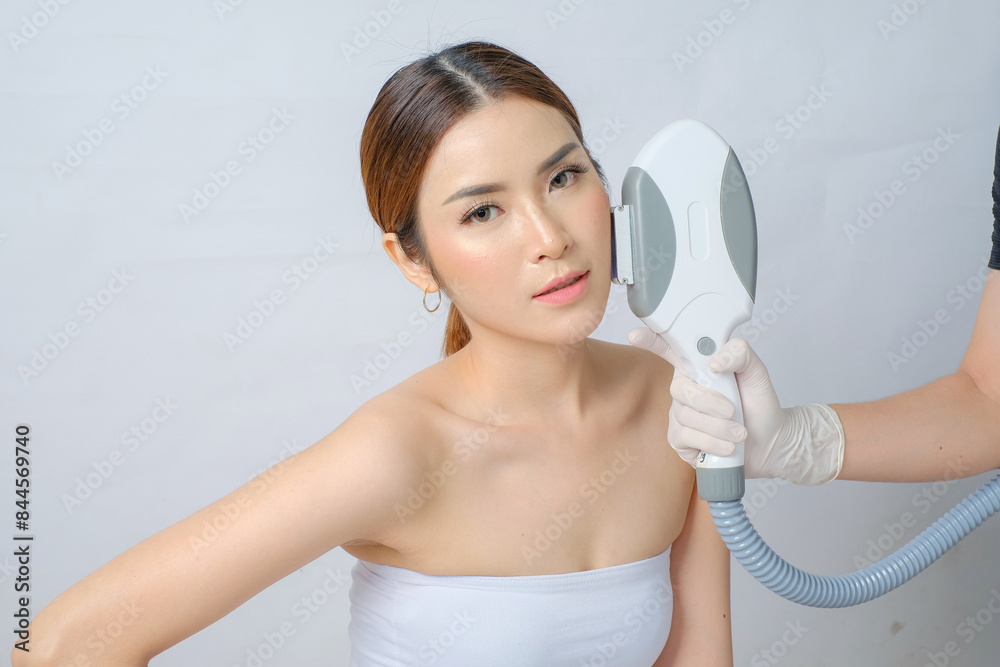 Radiant Asian Woman Receiving IPL (Intense Pulsed Light) Treatment
