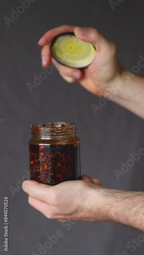 a bottle of sauce being opened
