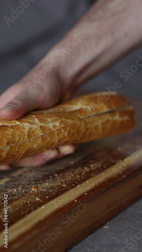 a hand slicing a sandwich