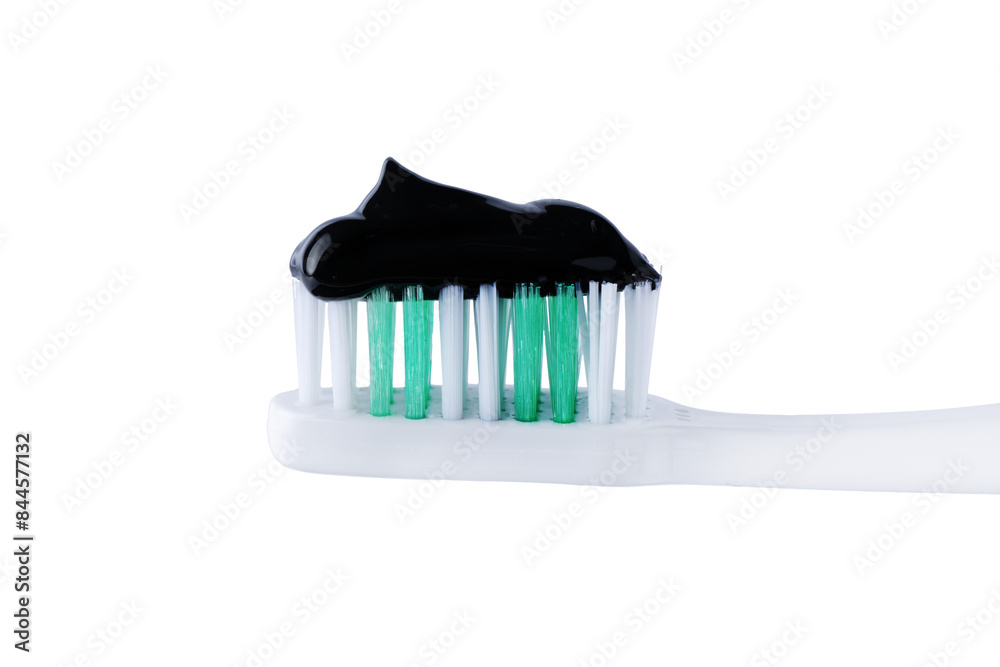 Charcoal toothpaste on toothbrush cut out on white background. Swatch of black charcoal whitening toothpaste on brush for design. Charcoal toothpaste on toothbrush cut out on white background. Swatch of black charcoal whitening toothpaste on brush for design.