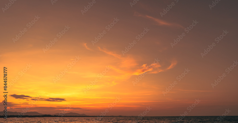 Sunset Sky clouds over horizon sea landscape in the evening summer season background, dramatic colorful orange, yellow sunlight fluffy after sundown on twilight, dusk sky backgrounds  