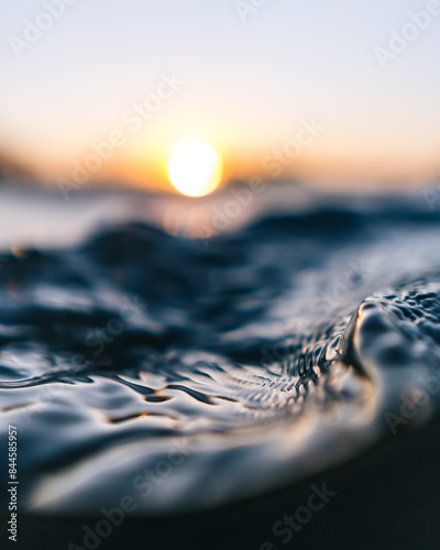 Macro shot of water surface in orange sunset