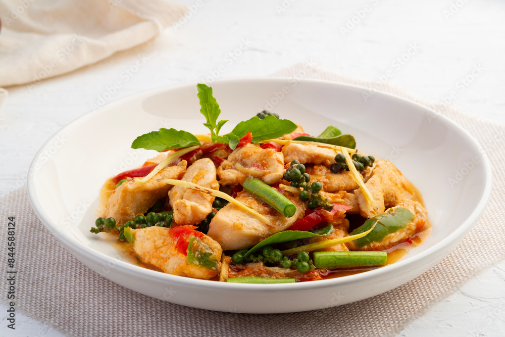 Spicy Stir Fried Chicken breast with chili and fingerroot in white plate.(Pad Cha) Spicy Stir Fried Chicken breast with chili and fingerroot in white plate.(Pad Cha)
