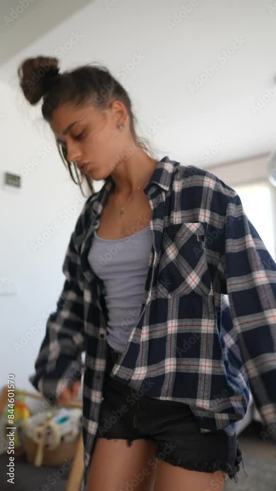 Woman is engaging in stretching exercises at home, dressed in a casual and comfortable outfit Woman is engaging in stretching exercises at home, dressed in a casual and comfortable outfit