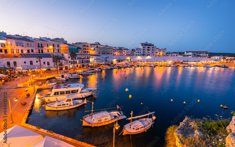 Evening view of the bay and picturesque harbor in the town of Es Castell on Menorca in Spain, Balearic Islands, Blue hour, Holiday resort