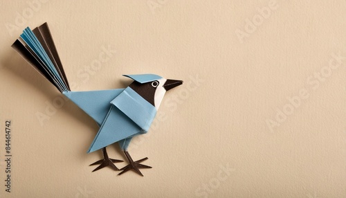 Animal concept origami isolated on white background of a blue jay - Cyanocitta cristata - is a passerine bird in the family Corvidae.  simple starter craft for kids, with copy space