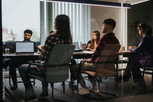A group of diverse businesspeople engaged in a meeting inside a contemporary office space, discussing data on a laptop screen, focusing on growth and results.