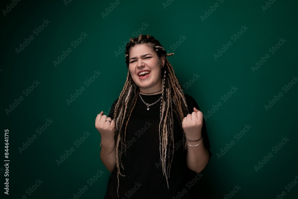 Woman With Dreadlocks Standing in Front of Green Wall Woman With Dreadlocks Standing in Front of Green Wall