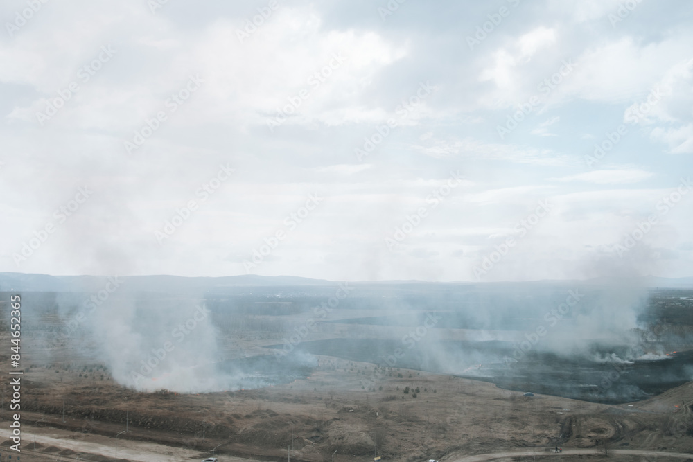 Aerial view of white smoke from forest fire rising up polluting atmosphere.= Aerial view of white smoke from forest fire rising up polluting atmosphere.=