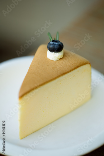Elegant cheesecake, blueberry adorned.