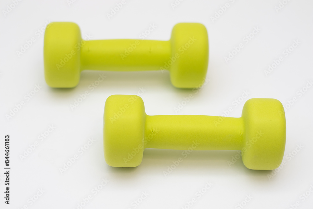 Green dumbbells on a white background good health concept. Green dumbbells on a white background good health concept.
