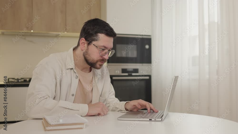 Surprised amazed man using laptop receive good news, shocked by sudden victory, celebrate lottery jackpot at home. Win gesture Surprised amazed man using laptop receive good news, shocked by sudden victory, celebrate lottery jackpot at home. Win gesture
