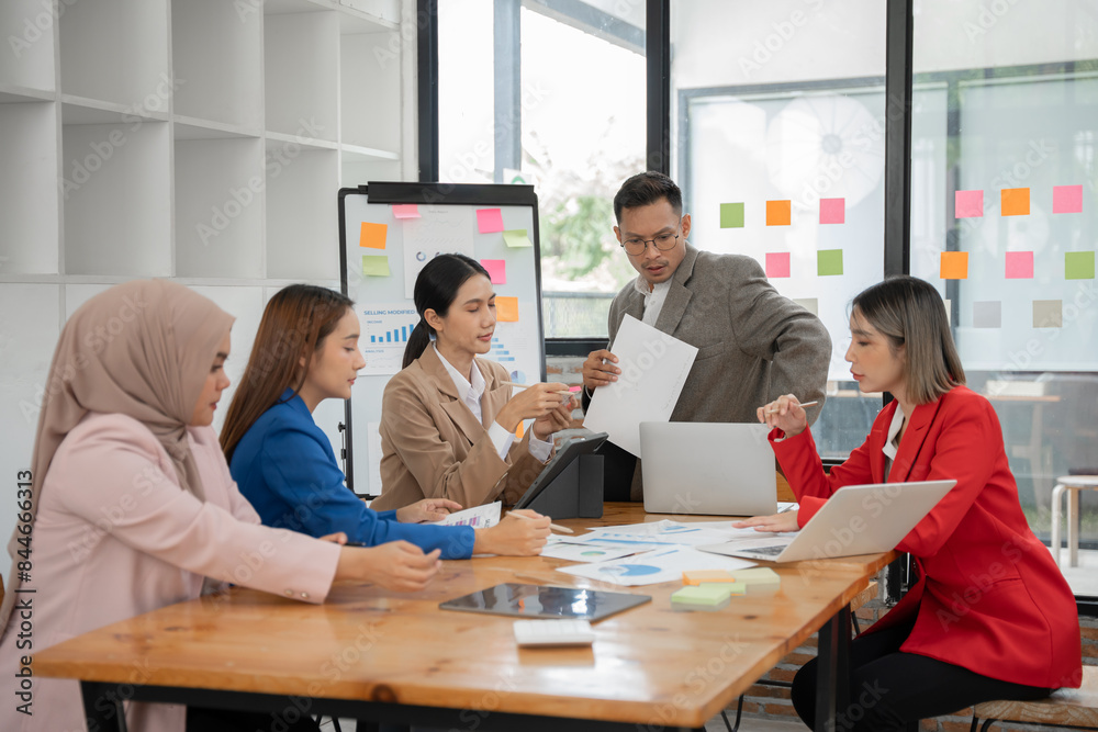 Group of Asian businessmen are presenting graphs on a whiteboard. Group of Asian businessmen are presenting graphs on a whiteboard.