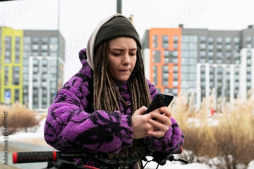 Bicycle rental concept. Young woman with dreadlocks rented a bicycle photo