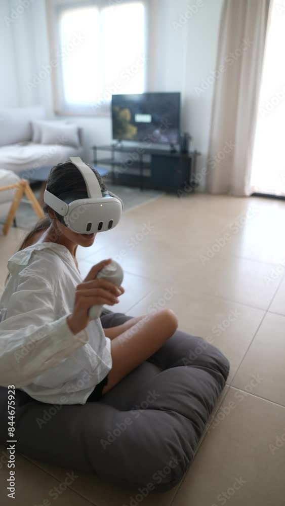 A young girl is immersed in interactive gaming in virtual reality in the comfort of her home A young girl is immersed in interactive gaming in virtual reality in the comfort of her home