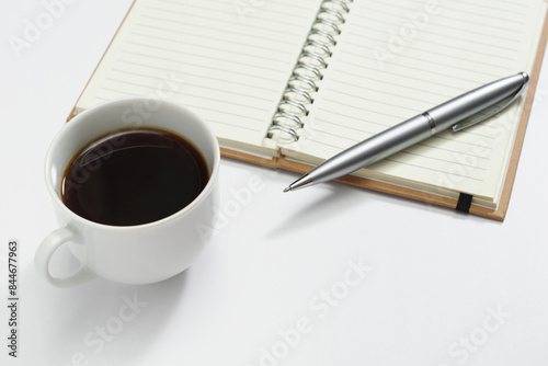 Cup of coffee, pen and notepad