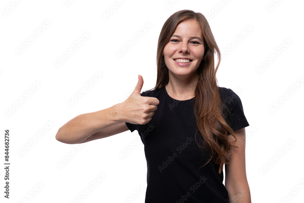 Caucasian brown-haired woman communicates an idea and holds a thumbs up Caucasian brown-haired woman communicates an idea and holds a thumbs up