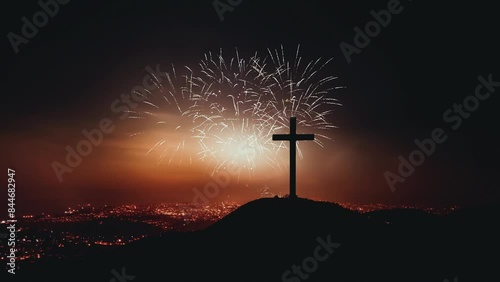 Fireworks festival celebrating the end of the year and New Year, cityscape and church cross silhouette at Christmas and New Year's night
