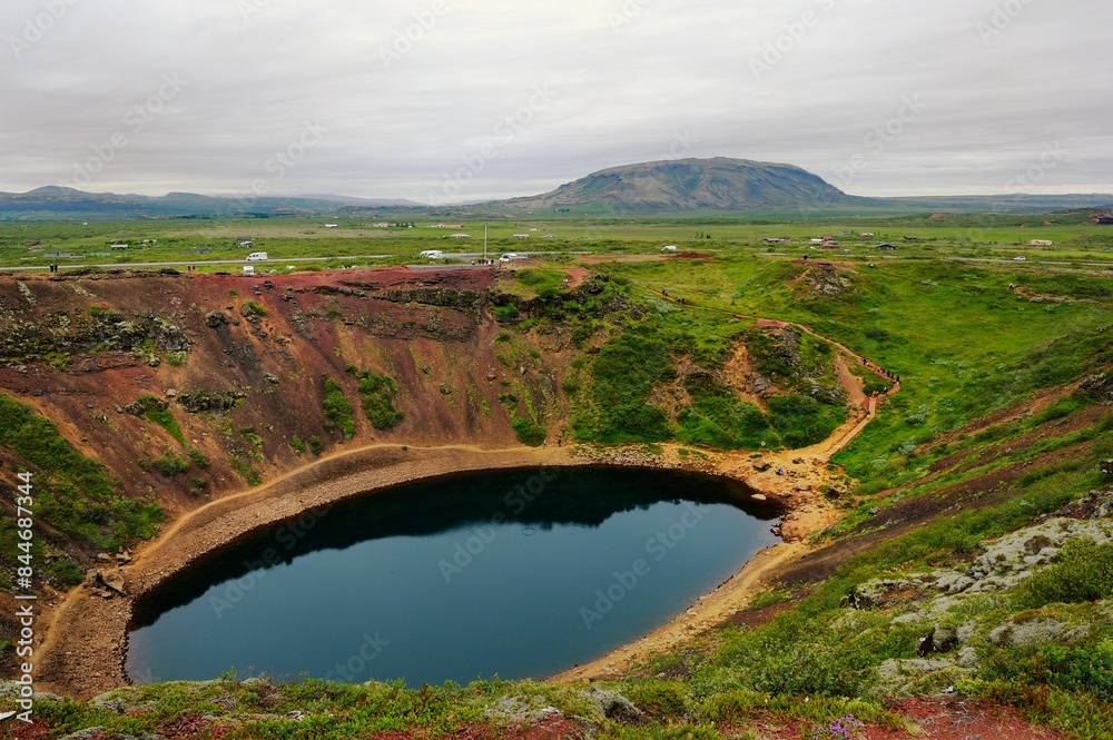 Fototapeta premium Visitors walking the volcano crater lip in Grimsnes-og Grafningshreppur