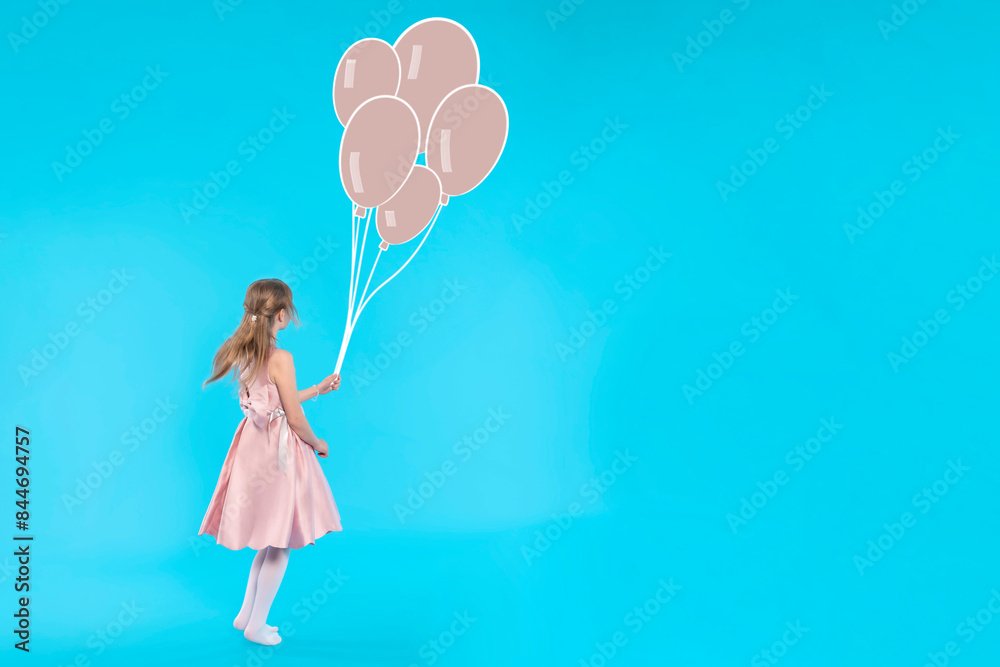 Young Girl in Pink Dress Holding Balloons Against Blue Background Young Girl in Pink Dress Holding Balloons Against Blue Background