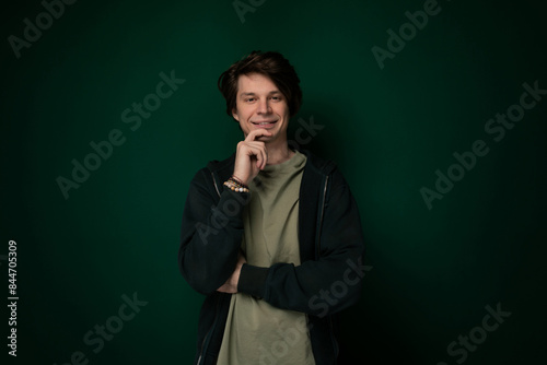 Man Standing in Front of Green Wall