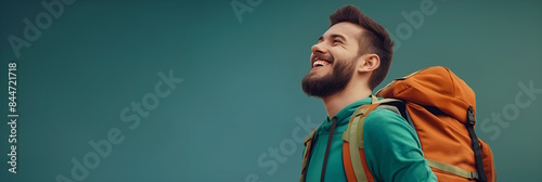 A happy young white man with a backpack enjoying travel and adventure