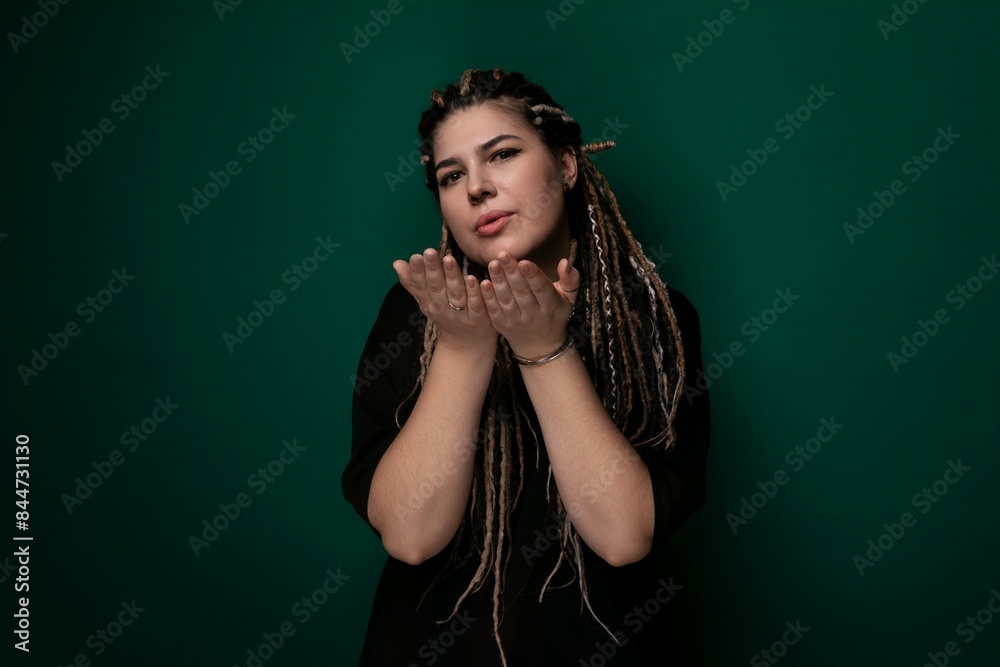 Woman With Dreadlocks Standing in Front of Green Wall Woman With Dreadlocks Standing in Front of Green Wall
