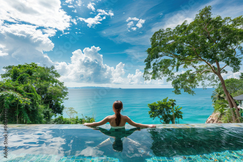 Swimsuit Model Relaxing on Infinity Swimming Pool at Luxury Villa Hotel in High-end Resort © Kien