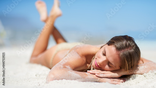 Fotografía Relax, lying and woman on beach for tanning, sunbathing and outdoor on seaside with calm