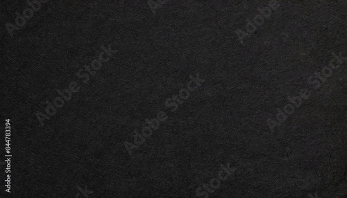Dark, dusty, grainy, rough, earthy handmade black paper texture with visible fibers, for minimalistic art or backgrounds.