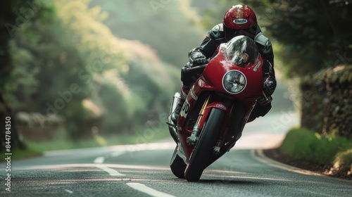 A man on a green motorcycle is racing down a road photo